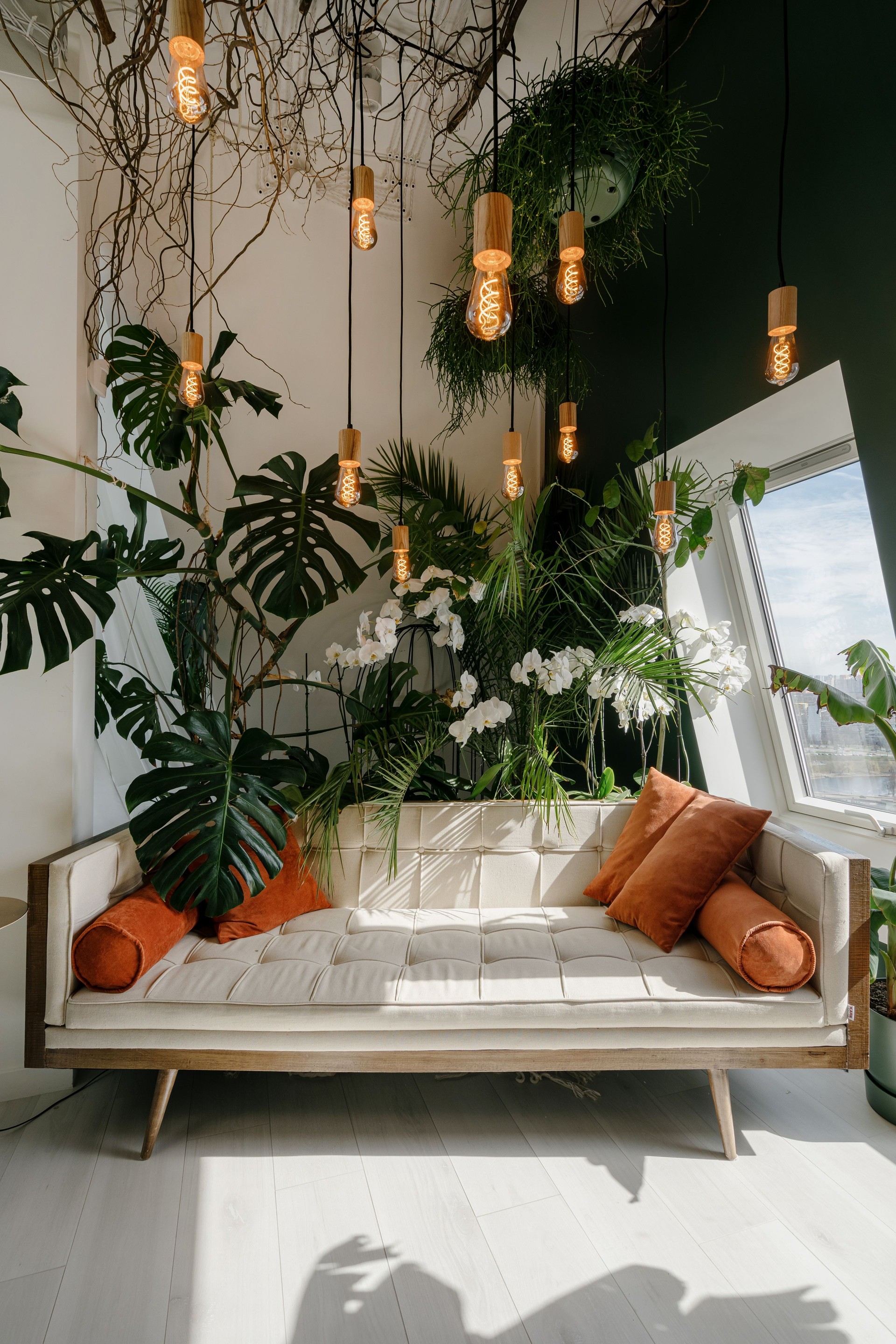 Couch and green plants in cozy living room